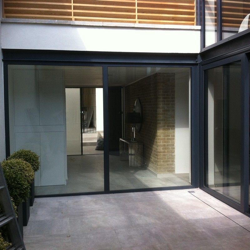 Floor-to-ceiling sliding doors opening to courtyard in Luton