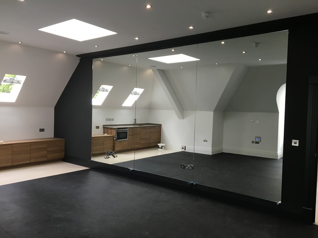 Frameless glass wall dividing loft conversion in Luton